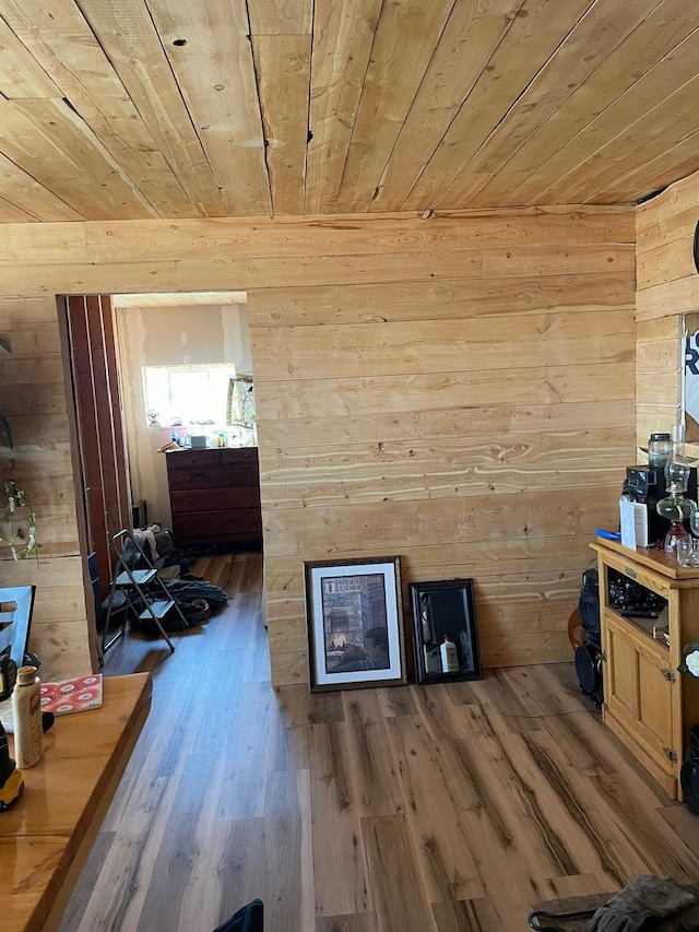 interior space featuring wood walls, wood ceiling, and wood finished floors