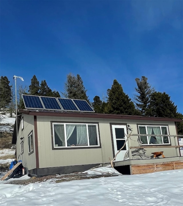 view of front of house with roof mounted solar panels