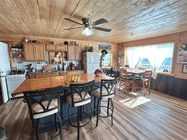 kitchen with wood ceiling, light wood-style flooring, brown cabinetry, white appliances, and open shelves