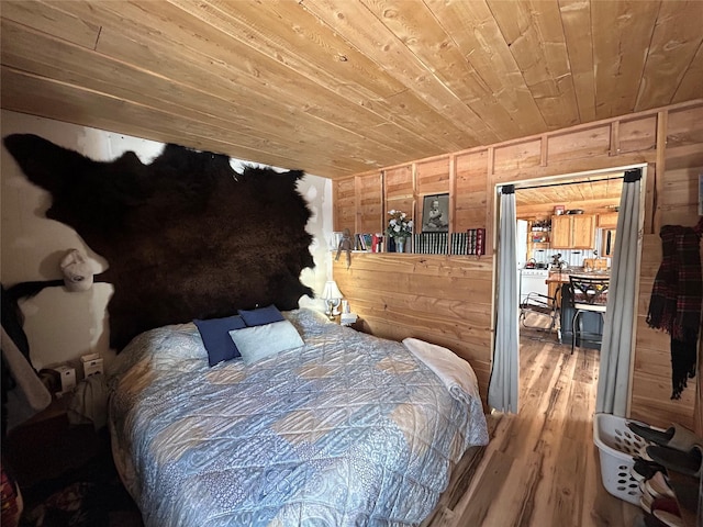 bedroom featuring wood finished floors, wooden walls, and wooden ceiling