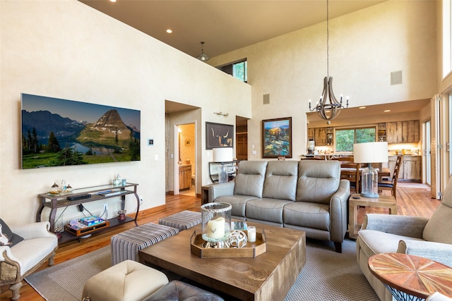 living area with light wood-type flooring, visible vents, recessed lighting, and an inviting chandelier