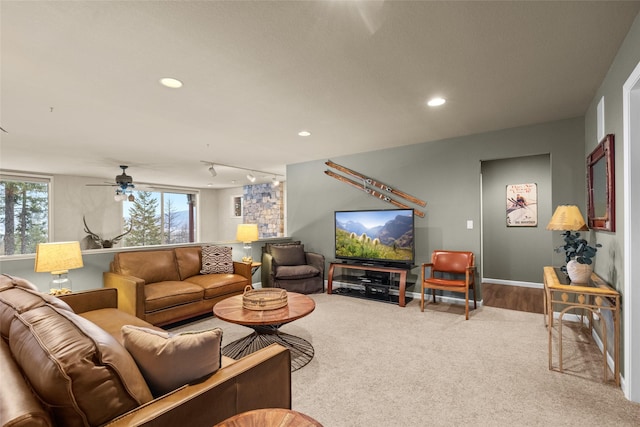 living area featuring carpet floors, recessed lighting, ceiling fan, and baseboards