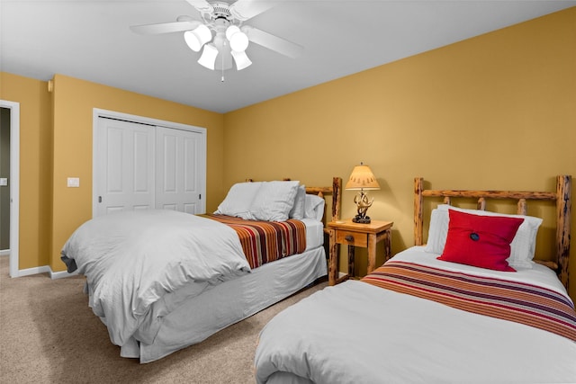 carpeted bedroom featuring a closet, ceiling fan, and baseboards