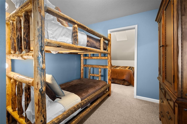 bedroom featuring carpet floors, a textured ceiling, and baseboards