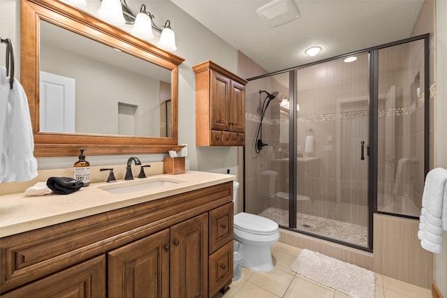 full bathroom with toilet, a stall shower, tile patterned flooring, and vanity