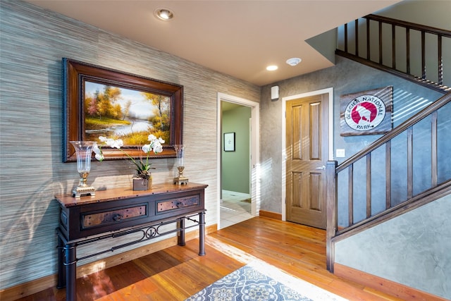 entrance foyer with baseboards, wallpapered walls, wood finished floors, and recessed lighting