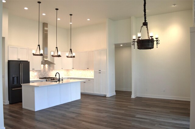 1228 Quail Ridge Dr, Kalispell, MT 59901 - kitchen with black fridge with ice dispenser, a high ceiling, dark wood-style floors, tasteful backsplash, and white cabinetry