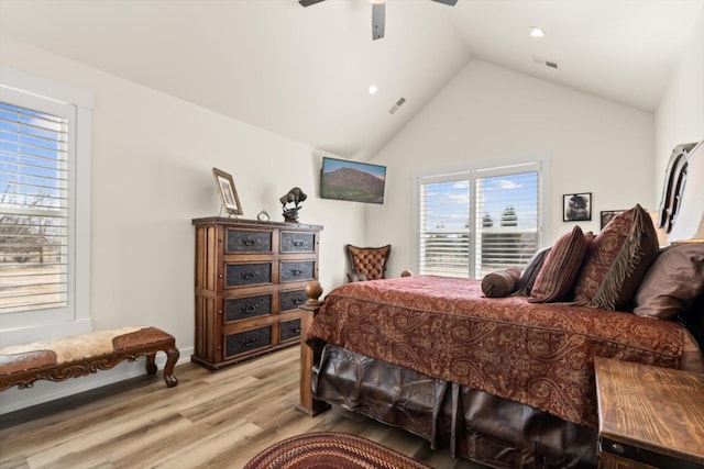 bedroom with lofted ceiling, light wood-type flooring, visible vents, and a ceiling fan