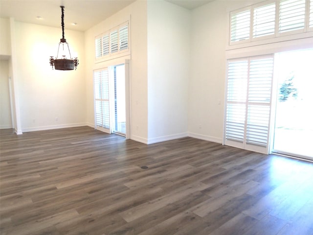 1228 Quail Ridge Dr, Kalispell, MT 59901 - empty room with a chandelier and dark wood-type flooring