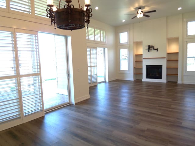 1228 Quail Ridge Dr, Kalispell, MT 59901 - unfurnished living room with healthy amount of natural light, dark wood-style flooring, recessed lighting, and a towering ceiling