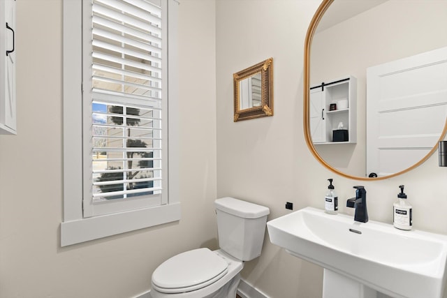 half bathroom with a sink and toilet