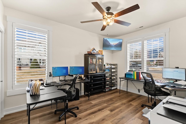 office with a ceiling fan, baseboards, visible vents, and wood finished floors