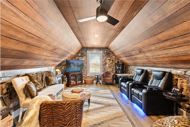 home theater room featuring lofted ceiling, wood ceiling, a ceiling fan, and wood finished floors