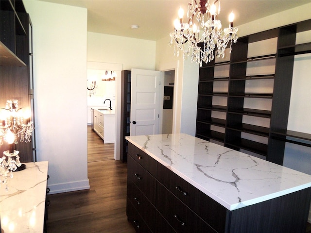1228 Quail Ridge Dr, Kalispell, MT 59901 - walk in closet featuring dark wood-style flooring and a chandelier