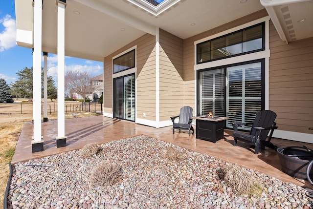 view of patio / terrace featuring an outdoor fire pit and fence