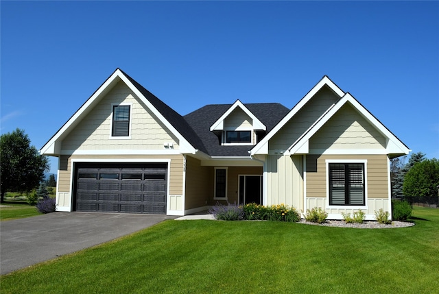 1228 Quail Ridge Dr, Kalispell, MT 59901 - view of front facade with a front lawn, asphalt driveway, an attached garage, board and batten siding, and roof with shingles