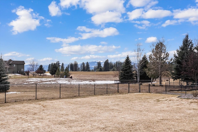 view of yard with fence and a rural view