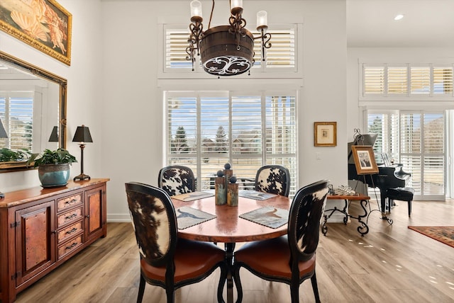 dining area with a chandelier and light wood-style floors