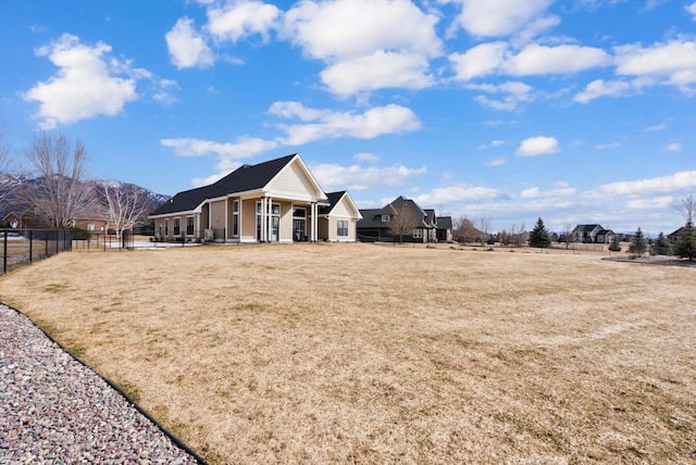 exterior space featuring a front lawn and fence