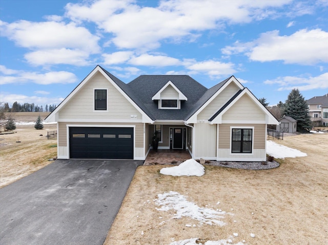 modern farmhouse featuring driveway and a shingled roof