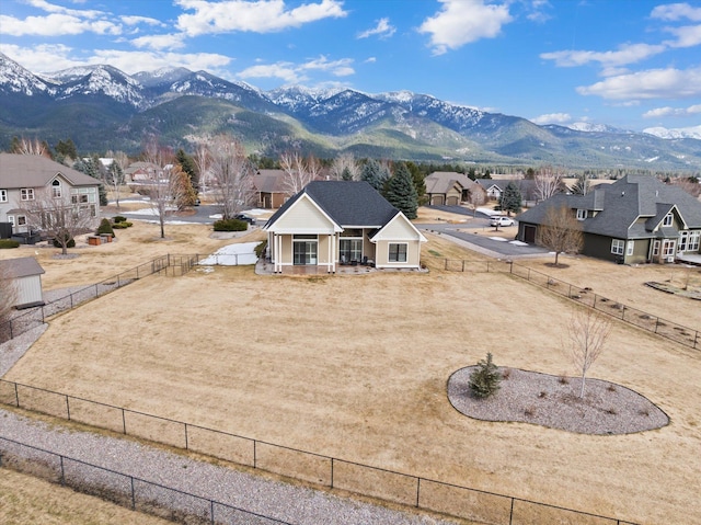 exterior space with a residential view, fence, a mountain view, and a porch