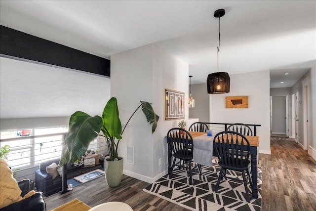 dining room featuring baseboards and wood finished floors