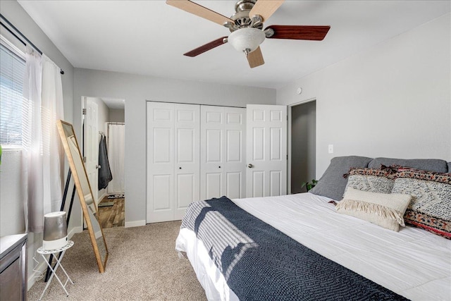 bedroom with light carpet, ceiling fan, baseboards, and a closet