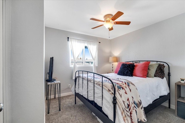 bedroom with a ceiling fan, carpet flooring, and baseboards