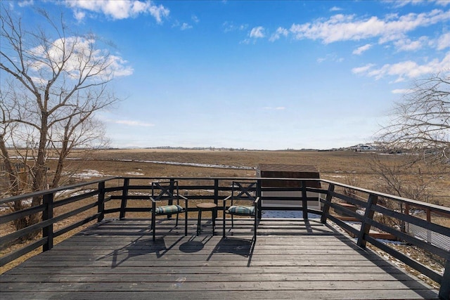 wooden terrace featuring a rural view