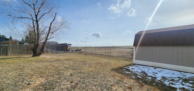 view of yard with an outbuilding and a fenced backyard