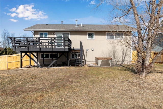 rear view of house featuring a lawn, fence, a deck, and stairs