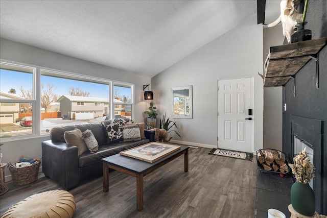 living room featuring a textured ceiling, high vaulted ceiling, wood finished floors, and baseboards