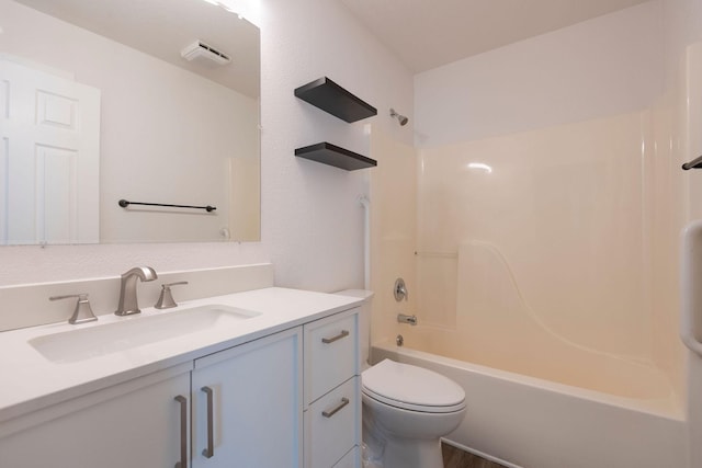 bathroom featuring toilet, shower / bathtub combination, and vanity