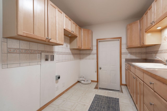 washroom featuring cabinet space, a sink, light floors, washer hookup, and electric dryer hookup