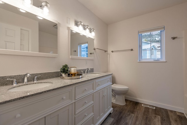 1949 University St, Helena, MT 59601 - bathroom featuring double vanity and wood finished floors
