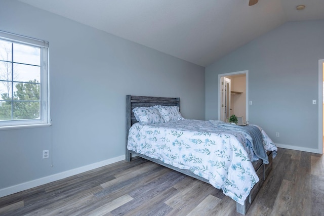 bedroom featuring vaulted ceiling, baseboards, and wood finished floors