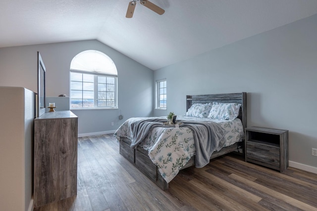 bedroom featuring a ceiling fan, dark wood-style flooring, vaulted ceiling, and baseboards