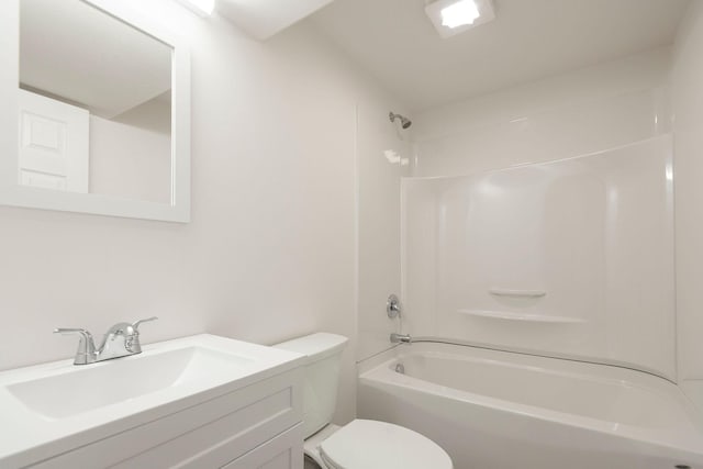 bathroom featuring  shower combination, vanity, and toilet