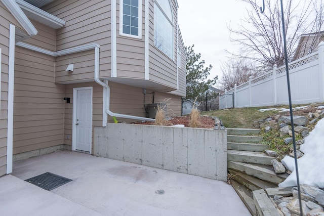 view of side of home with a patio and fence