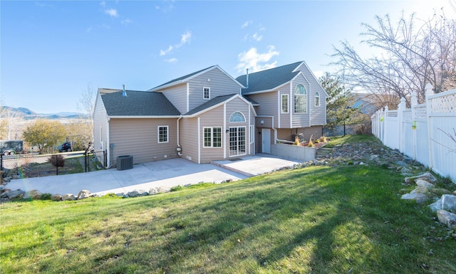 1949 University St, Helena, MT 59601 - back of house with a patio area, a fenced backyard, and a shingled roof