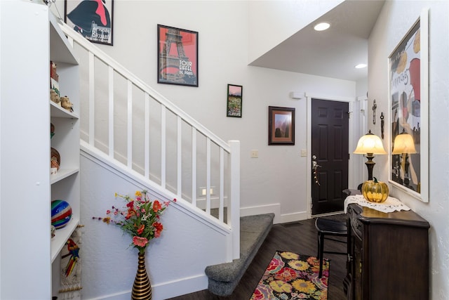 foyer entrance with recessed lighting, dark wood-style flooring, stairway, and baseboards