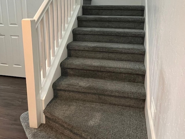 stairs featuring wood finished floors