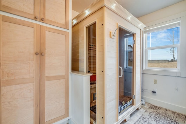 bathroom featuring a sauna, baseboards, and a shower stall