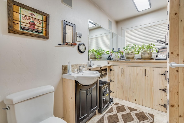 half bath featuring vanity and toilet