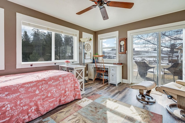 bedroom featuring a ceiling fan, baseboards, access to exterior, light wood-style floors, and built in desk