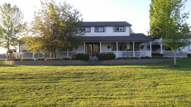 farmhouse with covered porch and a front lawn