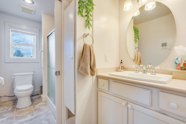 bathroom with vanity, toilet, and a shower stall