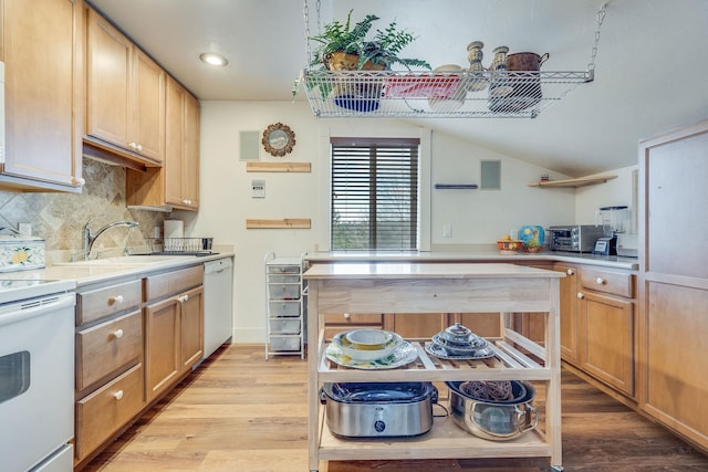 kitchen featuring light wood finished floors, a sink, dishwasher, electric range oven, and open shelves