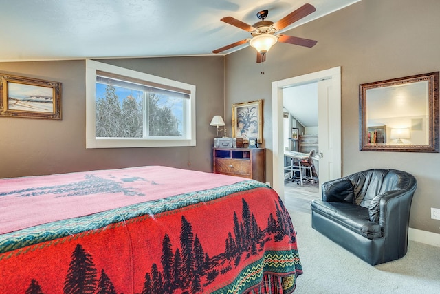 carpeted bedroom with ceiling fan and vaulted ceiling