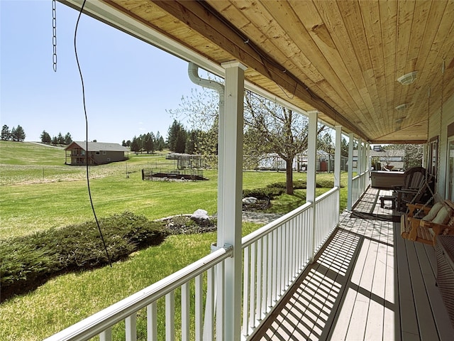 deck with a lawn and a porch